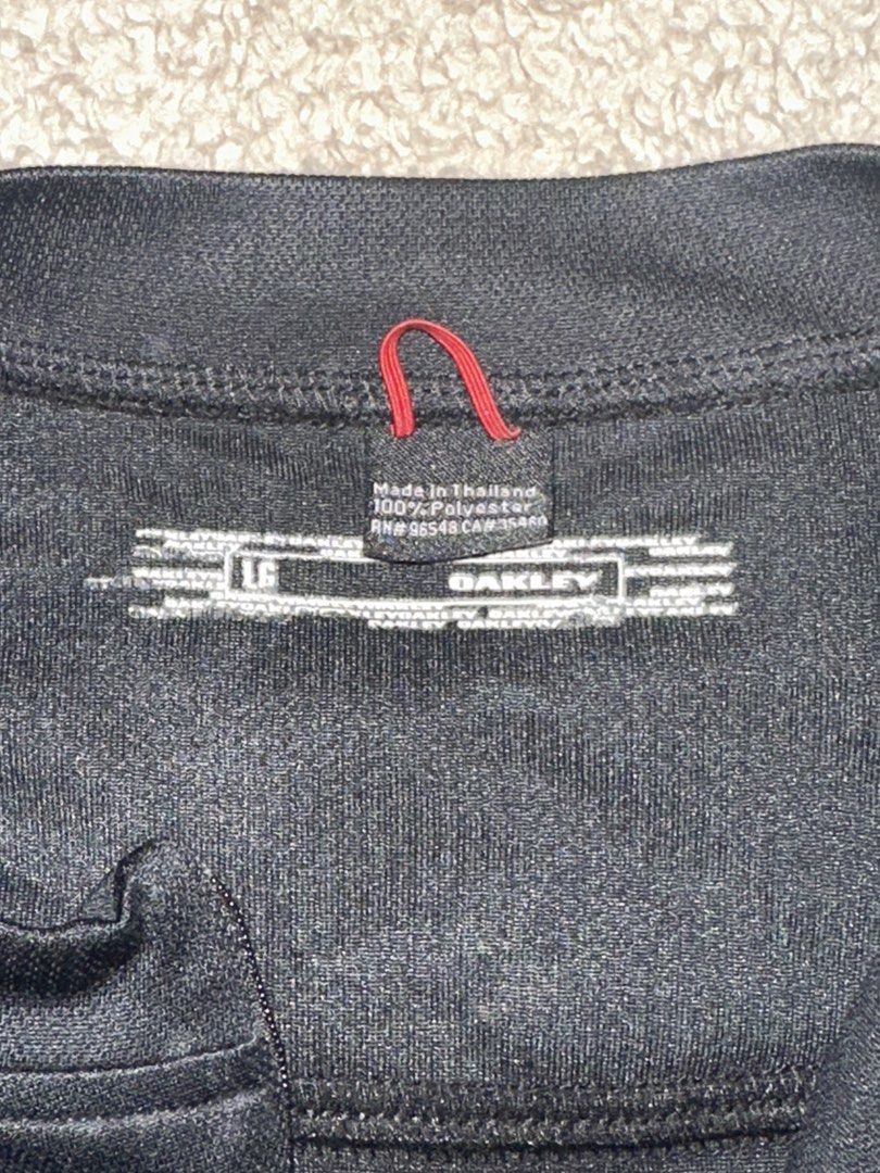 Oakley Black Half-Zip Athletic Shirt Size L (Category: Activewear) located in Quezon City. Submitted by mancave_stuff (Listing ID 1465087751, Image 3). Description: - Brand: Oakley - Color: Solid Black 10/10 rate - Size: Large (22” x 27”) - Design: Quarter-zip neckline with short sleeves -Breathable fabric - Details: White Oakley text logo on the right sleeve, small white ellipse logo near the front hem and back collar - - Condition: Excellent / 