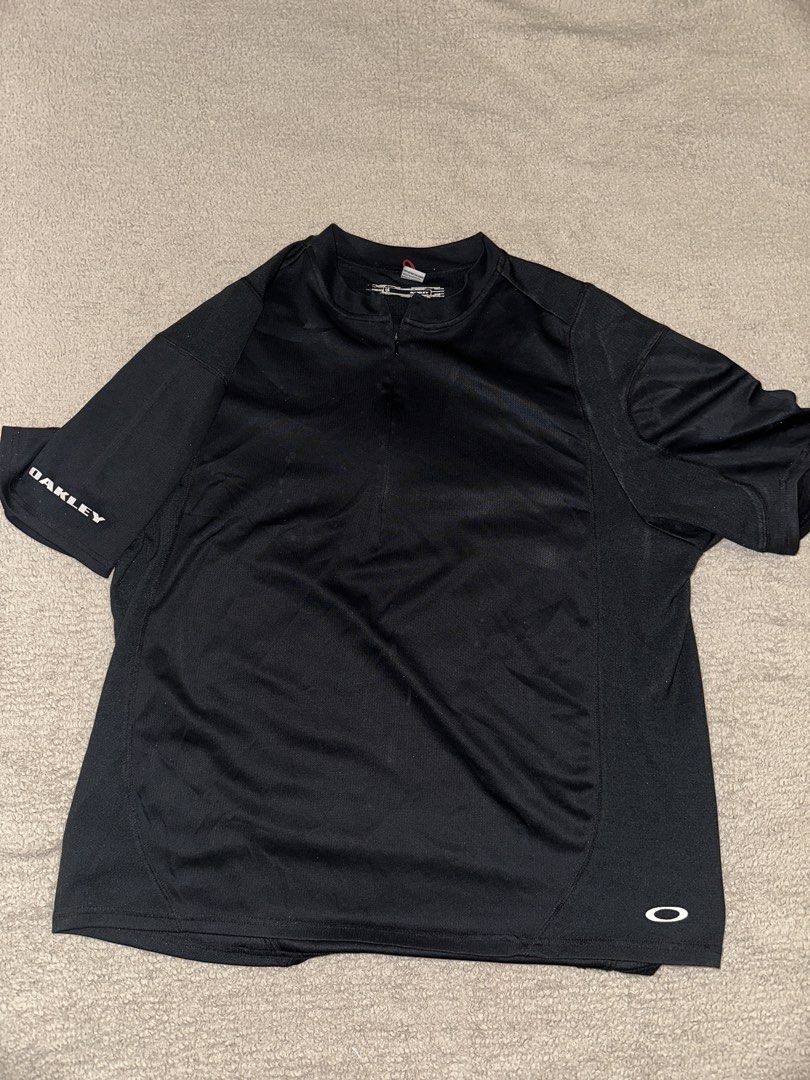 Oakley Black Half-Zip Athletic Shirt Size L (Category: Activewear) located in Quezon City. Submitted by mancave_stuff (Listing ID 1465087751, Image 1). Description: - Brand: Oakley - Color: Solid Black 10/10 rate - Size: Large (22” x 27”) - Design: Quarter-zip neckline with short sleeves -Breathable fabric - Details: White Oakley text logo on the right sleeve, small white ellipse logo near the front hem and back collar - - Condition: Excellent / 