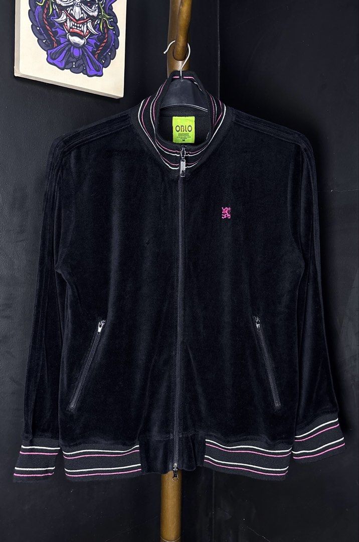 Oblo Nacional Black Track Jacket Size M (Category: Coats, Jackets and Outerwear) located in Bacoor. Submitted by calvinmanzano13 (Listing ID 1464982343, Image 1). Description: - L = 24” | W = 20” - Style: Track jacket in black velour - Details: Pink and white striped ribbing on collar, cuffs, and hem, plus a small pink embroidered crest logo - Hardware: Full zip closure with dual zipper pulls and secure zippered side pockets Notes: ☑️ Hand washed