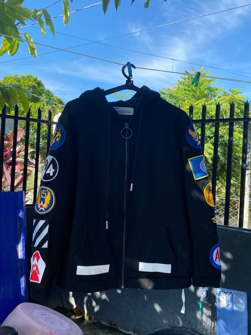 Offwhite Hoodie (Category: Coats, Jackets and Outerwear) located in Bacolod City. Submitted by chans_b_thrift (Listing ID 1465094670, Image 1). Description: - Color: Black - Closure: Front zipper with adjustable metal-aglet drawstrings - Pockets: Dual front pockets - Design: Eye-catching colorful patches on sleeves and iconic white diagonal stripes on the back and lower front - Interior: Warm and cozy fleece lining - Fit: Regular fit, true to siz