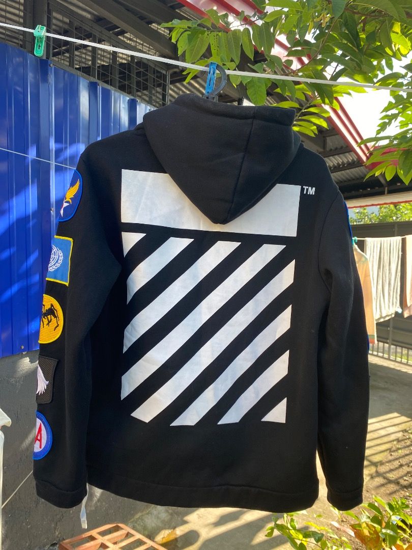 Offwhite Hoodie (Category: Coats, Jackets and Outerwear) located in Bacolod City. Submitted by chans_b_thrift (Listing ID 1465094670, Image 3). Description: - Color: Black - Closure: Front zipper with adjustable metal-aglet drawstrings - Pockets: Dual front pockets - Design: Eye-catching colorful patches on sleeves and iconic white diagonal stripes on the back and lower front - Interior: Warm and cozy fleece lining - Fit: Regular fit, true to siz