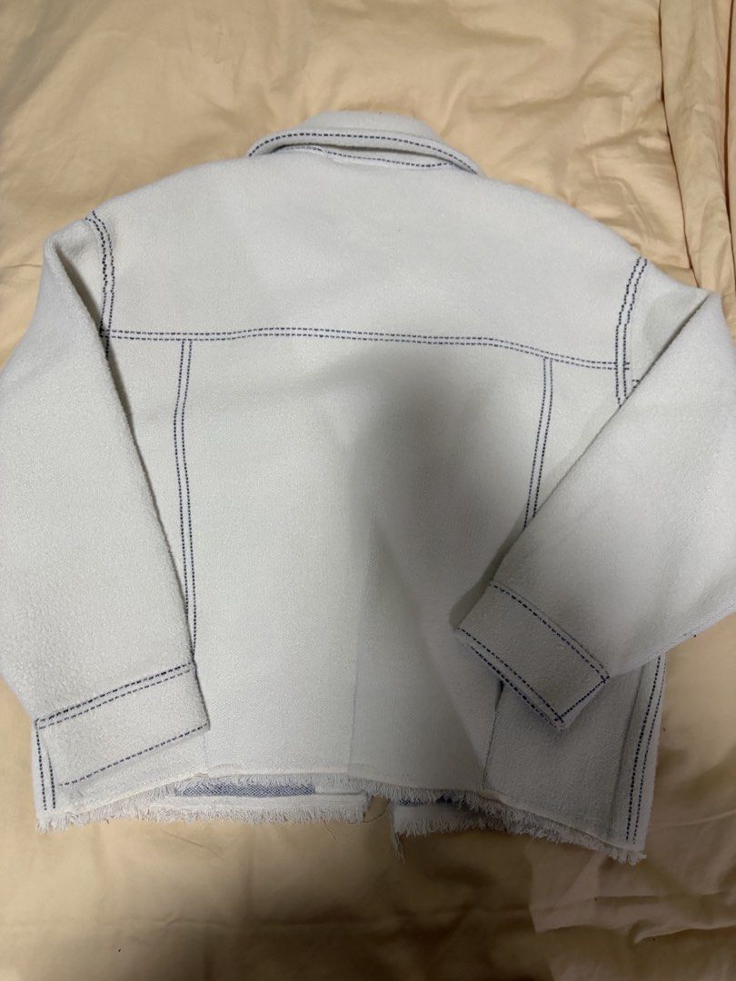 Off-white jacket with contrast stitching and pockets (Category: Coats, Jackets and Outerwear) located in Quezon City. Submitted by bluefrenchorn (Listing ID 1464982771, Image 3). Description: - Color/Style: Off-white textured jacket with dark contrast stitching - Features: Button-up front, two chest pockets, and a trendy frayed raw hem - Measurements: Pit to pit ~22 inches, Length ~22 inches, Sleeve length ~19 inches, shoulder 20 inches - Conditi
