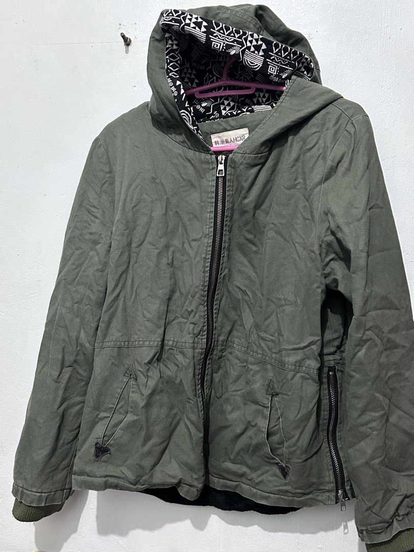 Olive Green Hooded Zip Jacket with Patterned Lining (Category: Coats, Jackets and Outerwear) located in Manila. Submitted by elnemeeh_05 (Listing ID 1465019665, Image 1). Description: - Color: Army green with black and white patterned hood lining - Closure: Full front zip - Pockets: Two slanted front pockets near the hem - Details: Unique extra zipper on the lower right side - Fit & Comfort: Ribbed knit cuffs and bottom hem to trap warmth - Condi