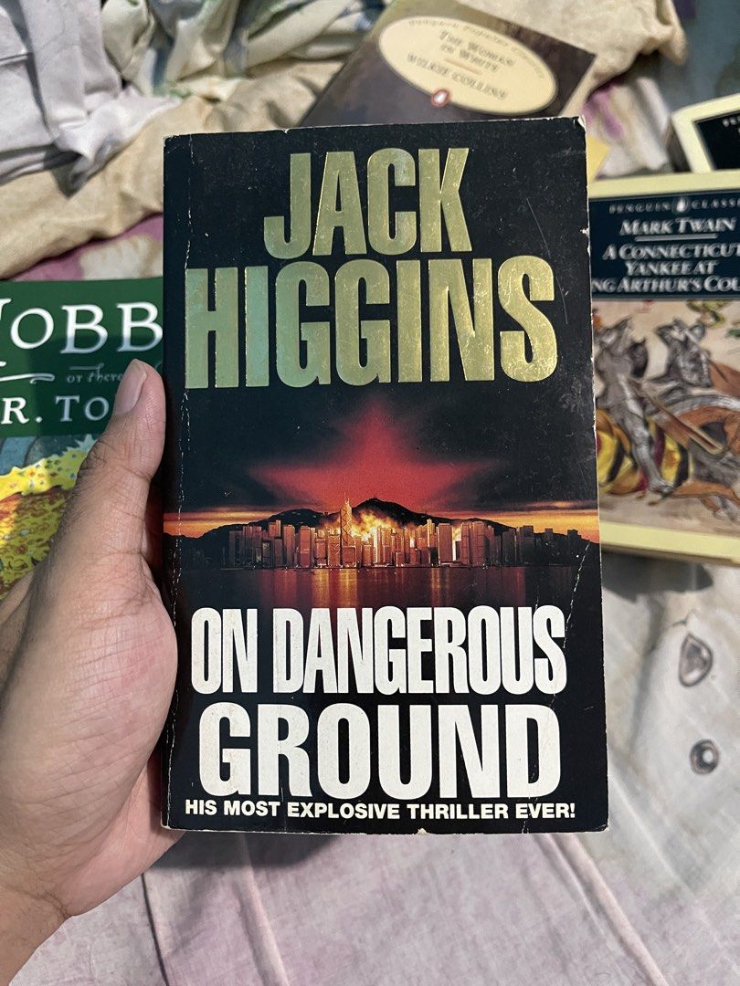 On Dangerous Ground by Jack Higgins Paperback Novel (Category: Storybooks) located in Bulacan. Submitted by keen72811 (Listing ID 1465098956, Image 1). Description: - Title: On Dangerous Ground by Jack Higgins - Genre: Political thriller and suspense fiction (Features Sean Dillon) - Format: Signet mass market paperback (ISBN: 0-45-118175-1) - Condition: Pre-loved with vintage page yellowing and minor cover edge wear - Perfect for: Thriller fans l