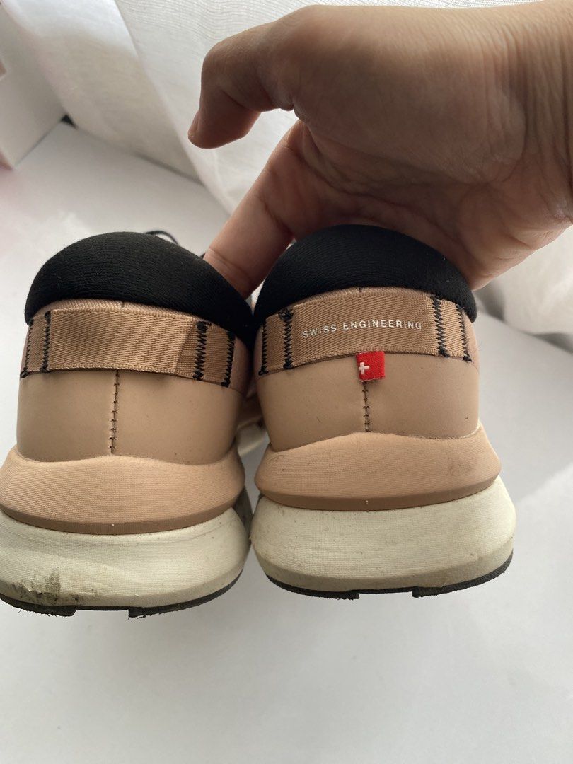 On Running Cloud Shoes Rose Gold Black (Category: Sneakers) located in Las Pinas. Submitted by gyuccaine (Listing ID 1465012939, Image 3). Description: - Color: Rose gold upper with contrasting black laces and collar - Sole: White CloudTec sole for all-day comfort - Details: Signature Swiss engineering label on the heel counter - Condition: Good everyday condition with visible wear on the bottom tread and edges - Style: Versatile athletic sneaker