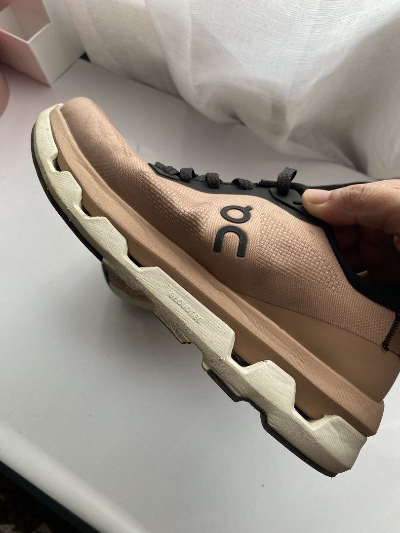 On Running Cloud Shoes Rose Gold Black (Category: Sneakers) located in Las Pinas. Submitted by gyuccaine (Listing ID 1465012939, Image 2). Description: - Color: Rose gold upper with contrasting black laces and collar - Sole: White CloudTec sole for all-day comfort - Details: Signature Swiss engineering label on the heel counter - Condition: Good everyday condition with visible wear on the bottom tread and edges - Style: Versatile athletic sneaker