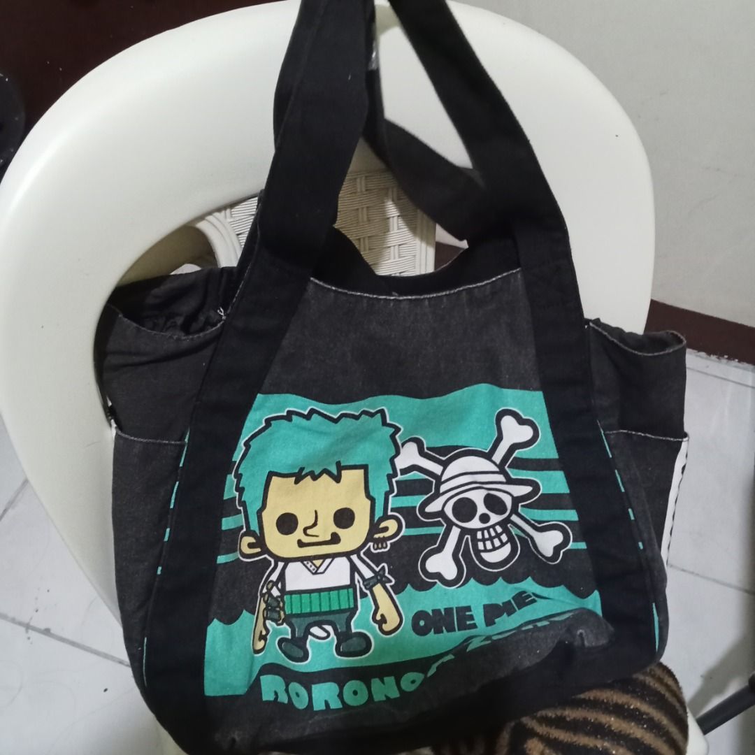 One Piece Anime Tote Bag (Category: Tote Bags) located in Quezon City. Submitted by trinket_cat (Listing ID 1464987690, Image 1). Description: - Design: Black canvas body with teal panels and bold white branding - Material: Cotton outer with polyester lining (Model: K-1918) - Perfect for: Daily use, school, or casual trips for anime fans - Condition: Good quality and ready to ship - Location: Metro Manila, Philippines (Fast shipping available!).