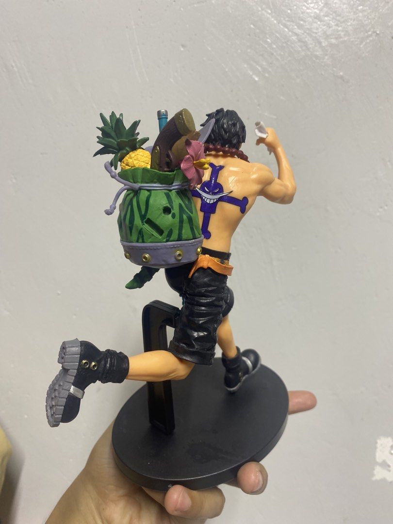 One Piece Portgas D Ace Figure (Category: Figurines & Statues) located in Pasacao. Submitted by wengpullar37205 (Listing ID 1465096771, Image 2). Description: - Character: Portgas D Ace (One Piece) - Pose: Dynamic running pose with food in mouth - Details: Backpack packed with supplies and clearly visible Whitebeard back tattoo - Inclusions: Black round display stand with support peg - Condition: Brand new / High-detailed sculpt - Shipping: Ships