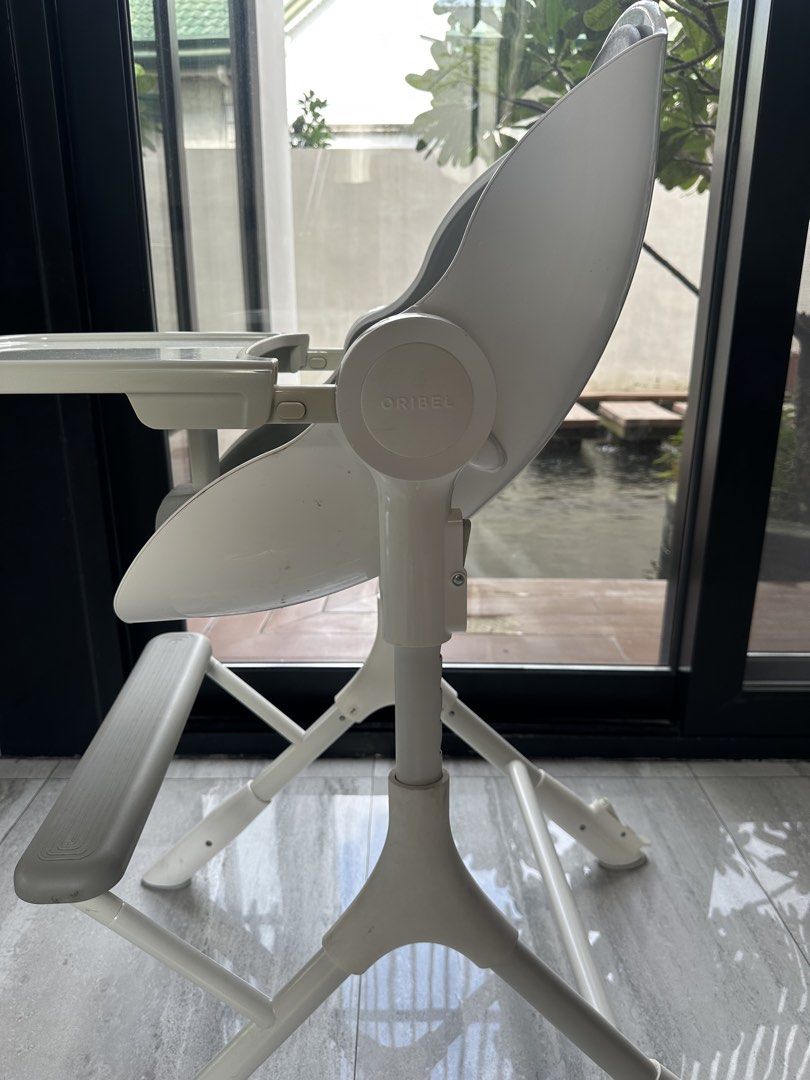Oribel Cocoon High Chair (Category: Baby High Chairs) located in Angeles City. Submitted by shopmycloset_101 (Listing ID 1464974977, Image 2). Description: - Brand: Oribel Cocoon High Chair - Color: White and Grey - Features: Adjustable height and recline positions - Tray: Removable for easy cleaning - Safety: Includes built-in safety harness and footrest - Mobility: Sturdy frame with front wheels for easy shifting - Condition: Clean and well-mai