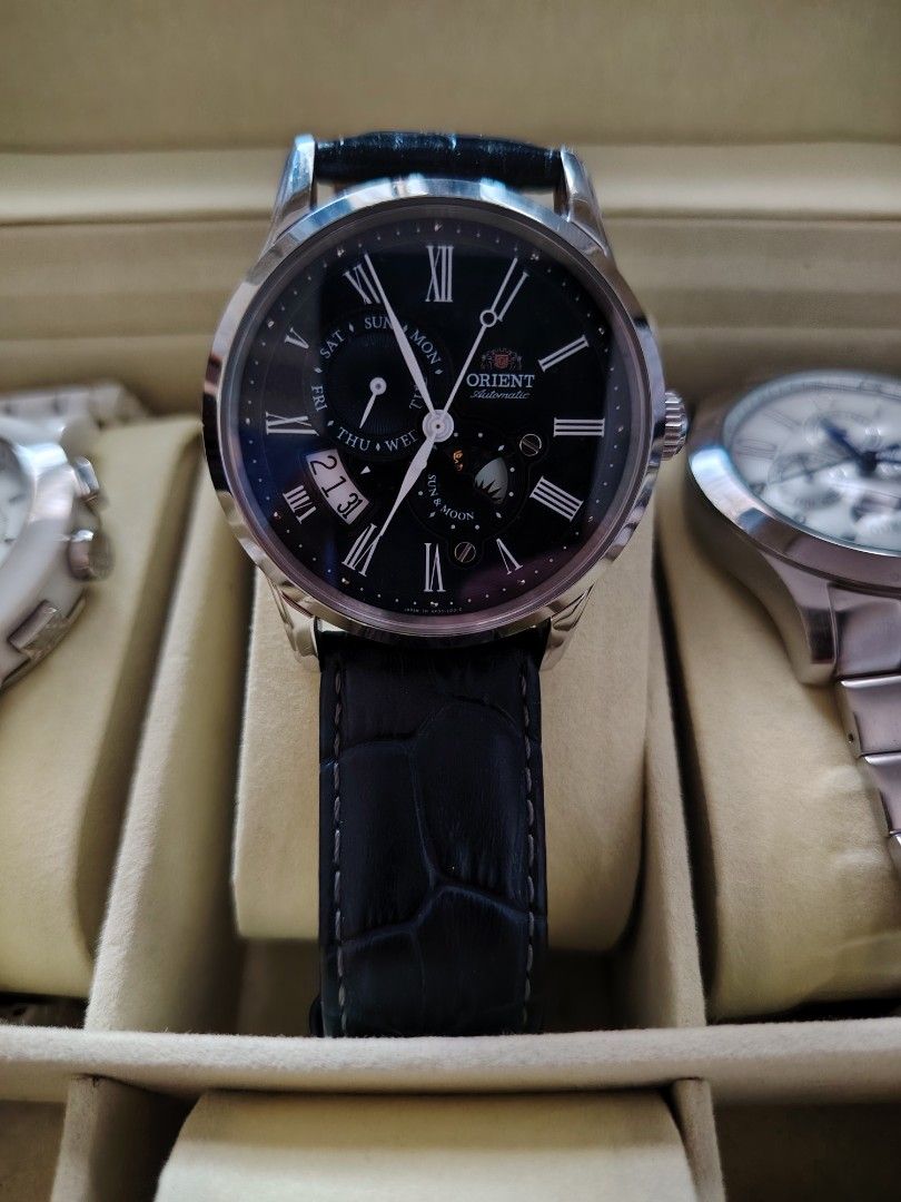 Orient Automatic Sun and Moon Watch with Black Leather Strap (Category: Men's Watches) located in Paranaque City. Submitted by lucille1280 (Listing ID 1464990801, Image 1). Description: - Brand: Orient Automatic Watch - Dial: Classic black with elegant Roman numerals - Features: Day subdial (left), Sun and -negotiable Moon indicator (bottom), and Date window (near 7 o'clock) - Case: Durable stainless steel with an exhibition case back to view the