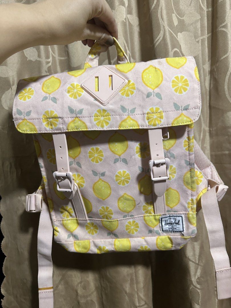 Original Herschel Supply Co. Nova Mini Backpack Lemon Print (Category: Kids Wardrobes & Storage) located in Manila. Submitted by edgiedge (Listing ID 1465056065, Image 2). Description: - 100% Authentic Herschel Supply Co. Nova Mini Backpack - Pastel pink straps, top handle, and magnetic snap buckles - well-maintained condition ₱400.
