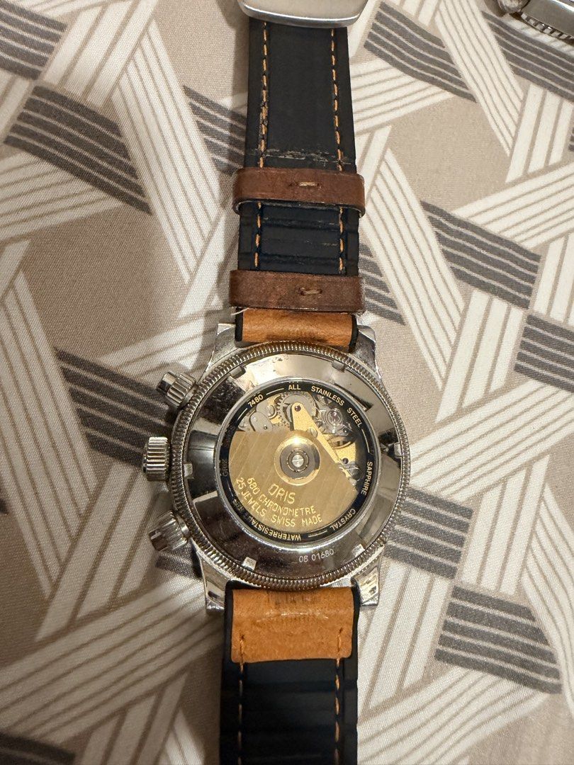 Oris Automatic Chronograph Chronometre 7480 Watch (Category: Men's Watches) located in Manila. Submitted by jack81472 (Listing ID 1465081605, Image 2). Description: - Brand: Oris - Movement: Automatic chronograph (Calibre 680, 25 jewels) with exhibition caseback - Dial: Black dial featuring three sub-dials, tachymeter scale, and date window at 3 o'clock - Case: Stainless steel with signature coin-edge design; price is negotiable - Strap: Tan leat