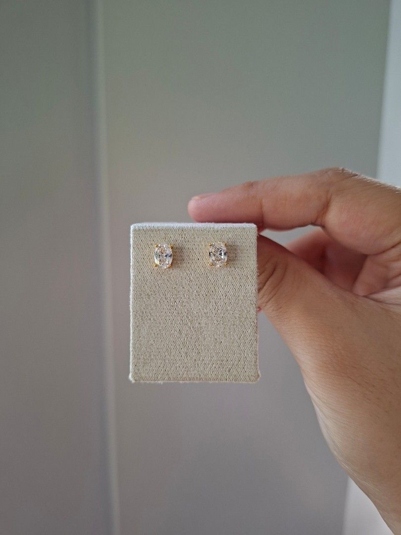 Oval White Crystal Gold Stud Earrings (Category: Earrings) located in Dasmarinas. Submitted by danabrie22 (Listing ID 1464989099, Image 2). Description: very well-made, excellent crafstmanship 10/10 condition brand new stainless steel & crystal-colored cubic zirconia stones made in Hongkong.