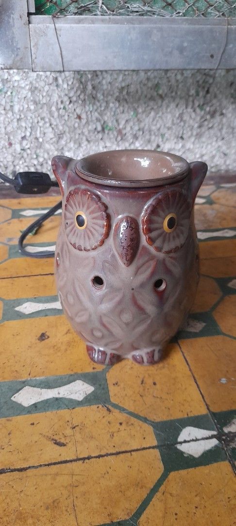 Owl Electric Wax Melt Warmer Ceramic Brown (Category: Home Fragrance) located in Valenzuela. Submitted by newbear.425b6e (Listing ID 1464996549, Image 1). Description: - Brown glazed ceramic owl design with cute carved eyes and textured body - Electric wax melt warmer and essential oil diffuser - Features a top well for scented wax tarts or oils - Built-in electric cord with a convenient switch included - Acts as both a charming home decor piece 