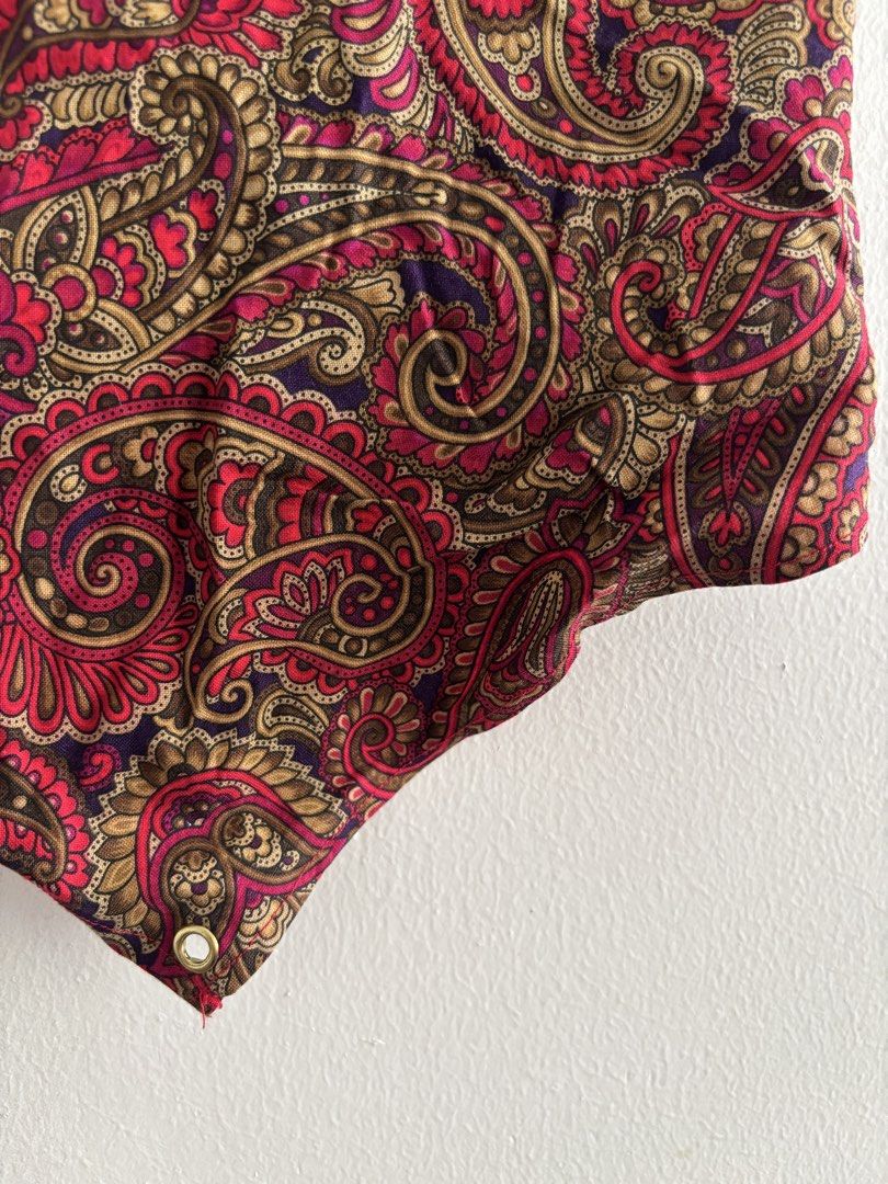 Paisley print lace-up back crop top (Category: Sleeveless) located in Muntinlupa City. Submitted by jc444_ (Listing ID 1465110741, Image 2). Description: - Style: Strapless bandeau top - Print/Color: Red and gold paisley - Details: Gold-toned metal grommets with light pink satin ribbon lace-up back - Hem: Unlined raw edge at the bottom point - Condition: Excellent.