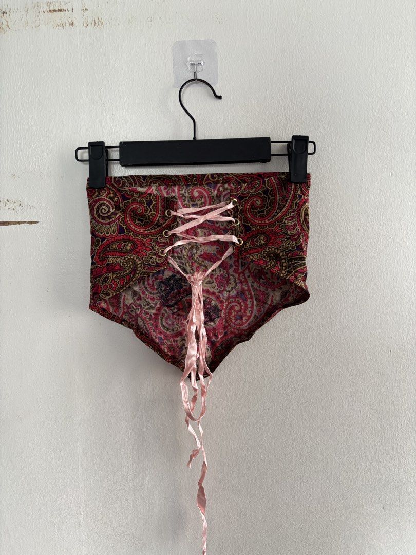 Paisley print lace-up back crop top (Category: Sleeveless) located in Muntinlupa City. Submitted by jc444_ (Listing ID 1465110741, Image 3). Description: - Style: Strapless bandeau top - Print/Color: Red and gold paisley - Details: Gold-toned metal grommets with light pink satin ribbon lace-up back - Hem: Unlined raw edge at the bottom point - Condition: Excellent.