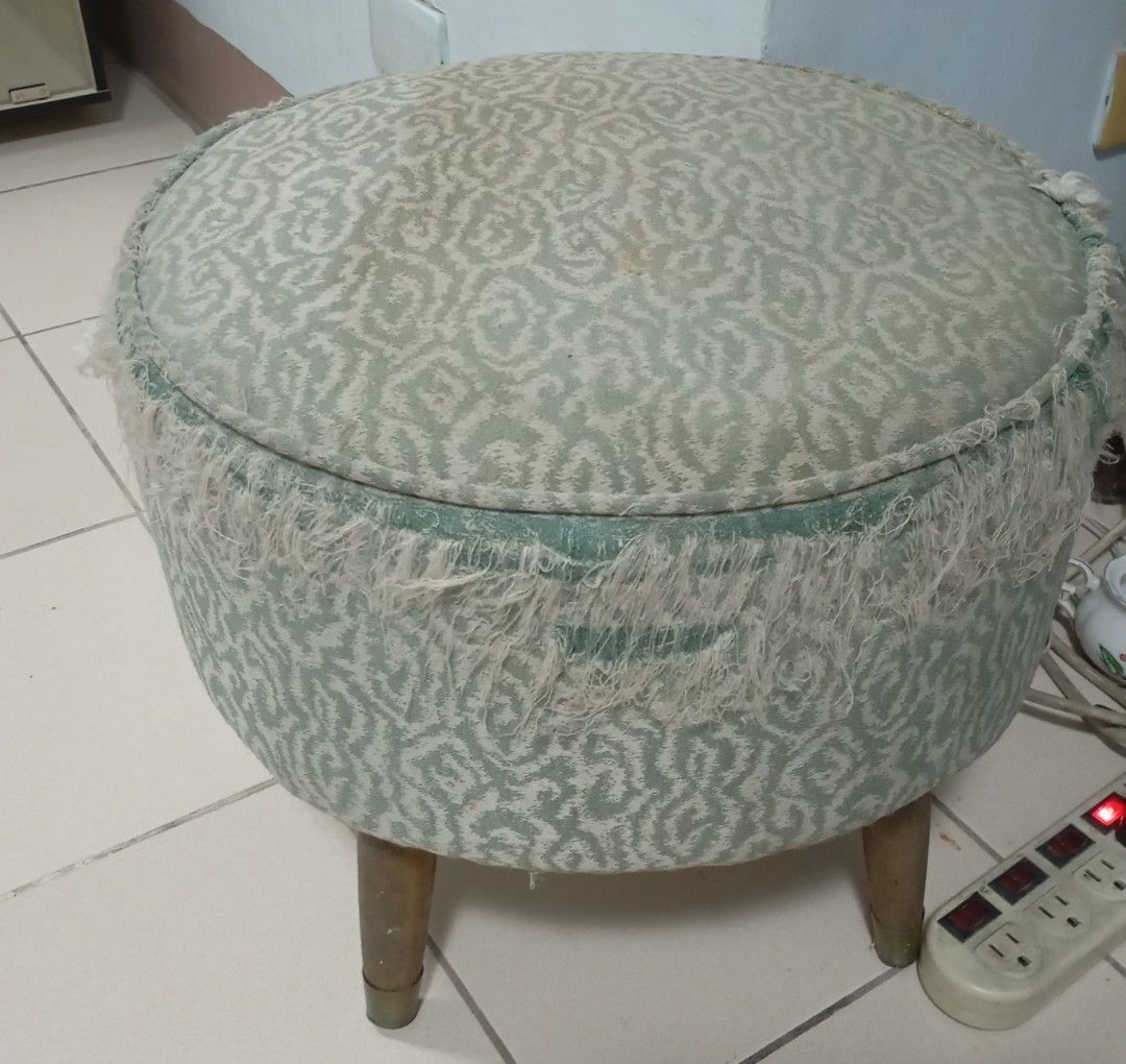 Patterned Fabric Round Footstool with Wooden Legs (Category: Chairs) located in Quezon City. Submitted by gdbye_things (Listing ID 1465083449, Image 1). Description: Just needs to be refurbished legs are very sturdy - Support: Four sturdy wooden legs and a solid internal structure - Condition: The fabric and structure are solid, but the fringed trim shows noticeable fraying all around - Note: Perfect and ready for a fun DIY upholstery project!.