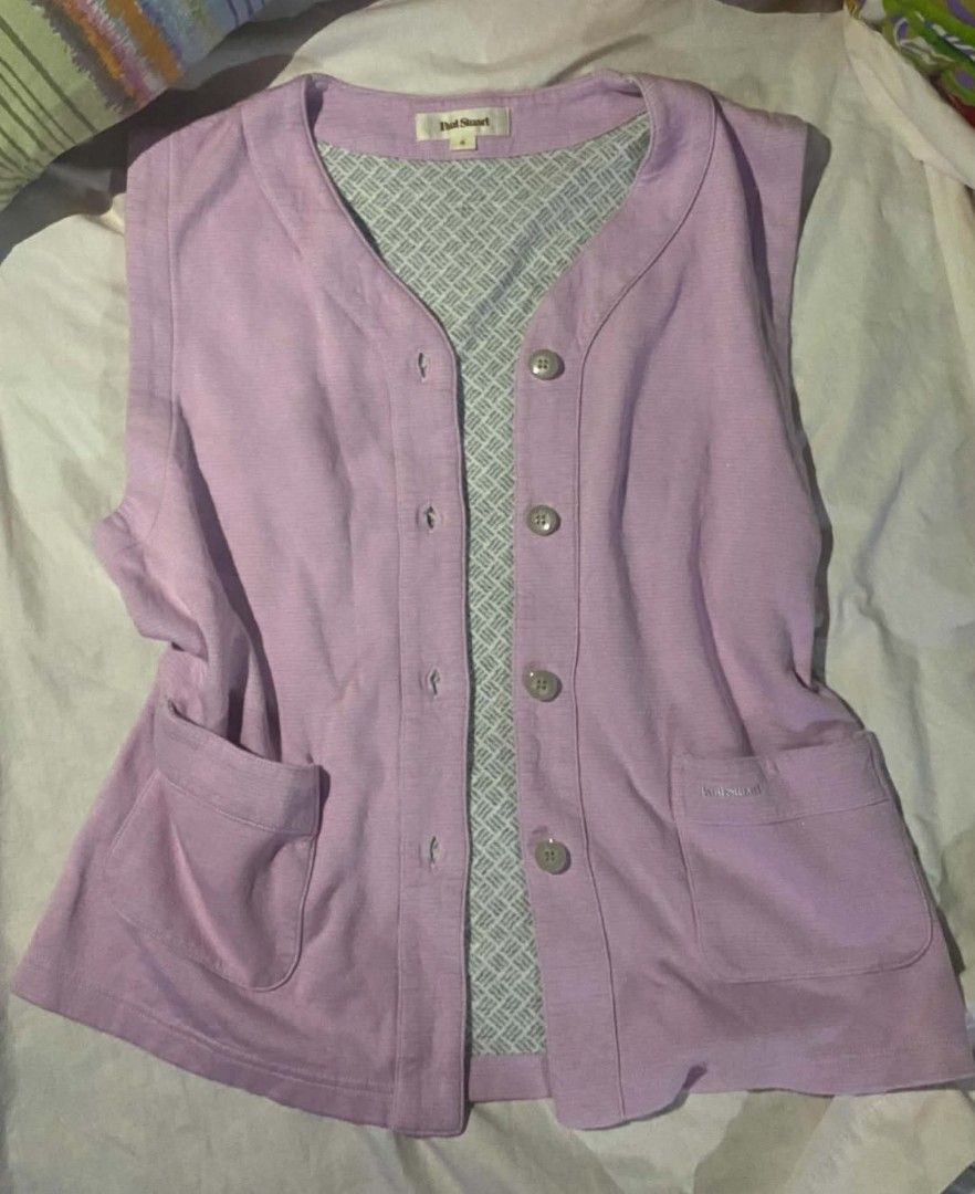 Paul Stuart Purple Button-Down Vest Size M (Category: Vests) located in Manila. Submitted by atashaaaaa (Listing ID 1465089313, Image 2). Description: - Brand/Style: Paul Stuart sleeveless vest - Color: Light purple with contrasting grey and white geometric inner lining - Closure & Pockets: Front button closure with 4 buttons and 2 front patch pockets with stitched logo detail - Neckline: V-neckline with a clean fabric texture - Fit/Usage: Great 