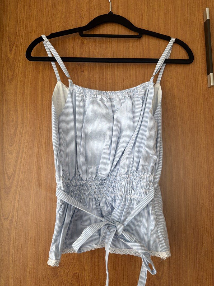 Phia blue and white striped cami top (Category: Sleeveless) located in Cavite. Submitted by klarev (Listing ID 1464995656, Image 2). Description: - Size: Small - Design: Light blue and white stripes with cute lace trim along the hem with smocked elastic back - Details: Adjustable spaghetti straps, sweetheart neckline, and a cute waist tie sash.