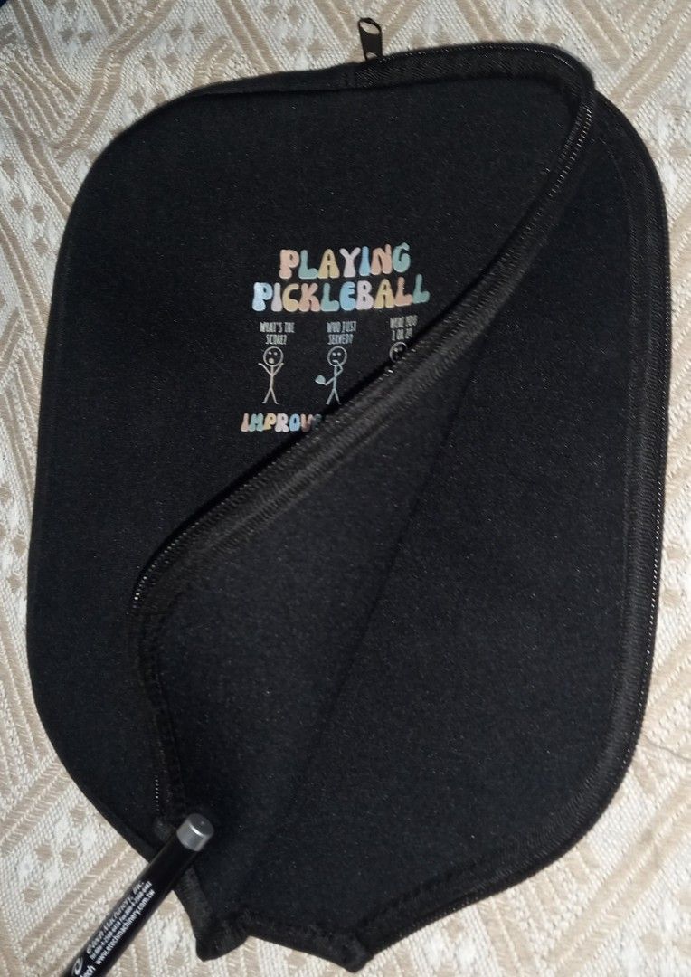 Pickleball Paddle Cover Black Zip Pouch (Category: Racket and Ball Sports) located in Cagayan de Oro. Submitted by edwardryan01984 (Listing ID 1465104267, Image 2). Description: - Color: Black - Material: Durable neoprene - Design: Graphic print with funny stick figure dialogue - Closure: Secure zipper - Fit: Standard shape fits most regular paddles - Function: Protects your paddle from scratches and dings inside your bag.