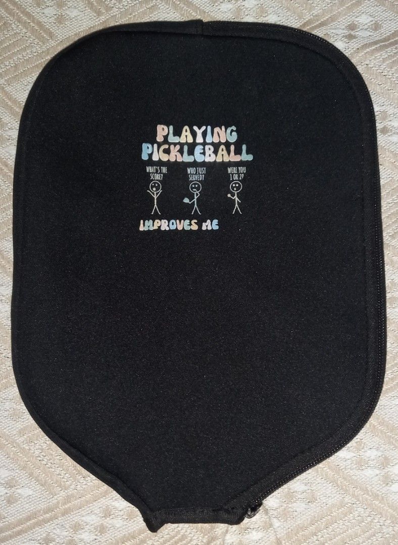 Pickleball Paddle Cover Black Zip Pouch (Category: Racket and Ball Sports) located in Cagayan de Oro. Submitted by edwardryan01984 (Listing ID 1465104267, Image 1). Description: - Color: Black - Material: Durable neoprene - Design: Graphic print with funny stick figure dialogue - Closure: Secure zipper - Fit: Standard shape fits most regular paddles - Function: Protects your paddle from scratches and dings inside your bag.