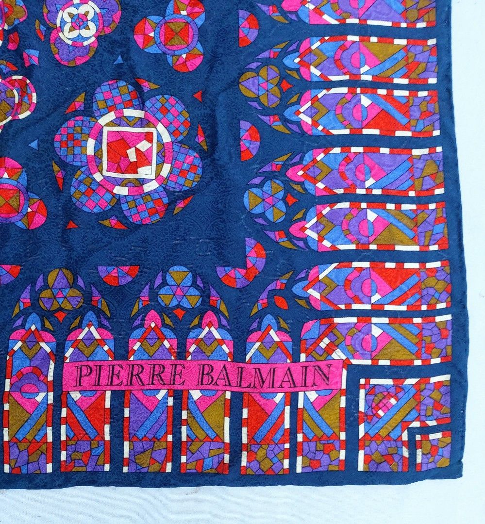 Pierre Balmain Paris Silk Scarf (Category: Scarves) located in Lapu Lapu. Submitted by agnesapm_29813 (Listing ID 1465102837, Image 3). Description: - Brand: Pierre Balmain - Material: 100% Silk with hand-rolled edges - Design: Vibrant stained glass rose window motif on a deep blue background with rich pink, purple, and red accents - Measurements: 41 x 41 inches .