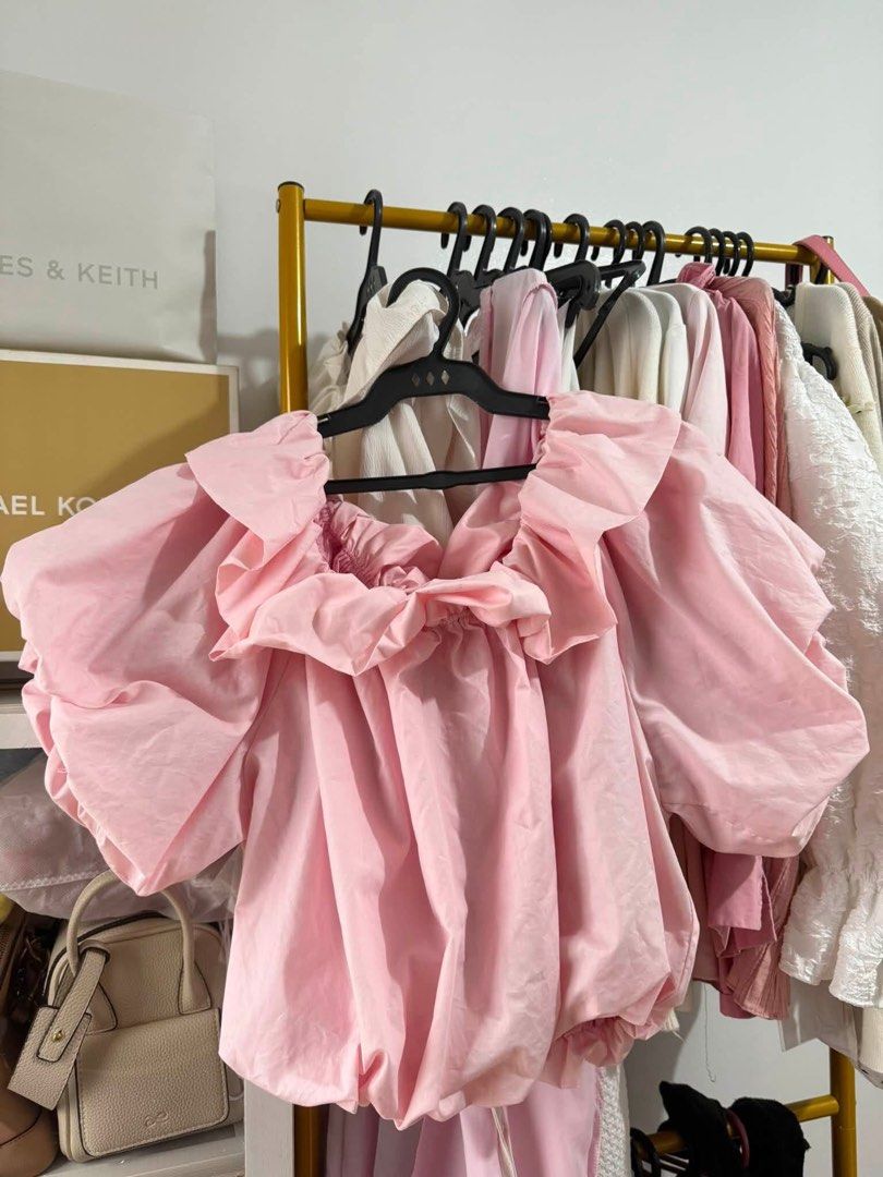 Pink Bubble Hem Puff Sleeve Blouse (Category: Blouses) located in Trece Martires City. Submitted by king2318 (Listing ID 1465004266, Image 1). Description: - Color: Baby pink - Design: Dramatic puff sleeves, oversized ruffle collar, and bubble hem - Material: Lightweight cotton or cotton-blend for all-day comfort - Styling: Pairs effortlessly with jeans or skirts - Occasion: Perfect for casual day outs, dates, or weekend errands - Condition: Bran