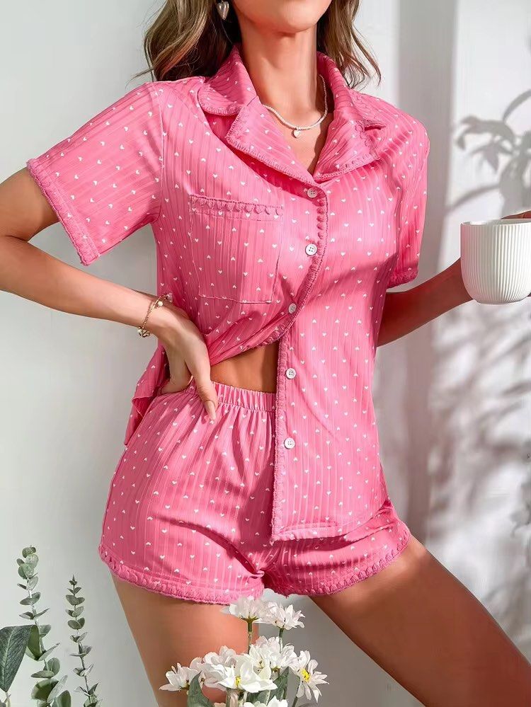 Pink Heart Pattern Short Sleeve Pajama Top (Category: Undergarments & Loungewear) located in Manila. Submitted by dianafayesimbre (Listing ID 1465073668, Image 2). Description: - Color/Pattern: Pink with white mini hearts - Material/Texture: Vertical ribbed texture - Design: Collared neckline, front button closure, small chest pocket - Fit: Relaxed fit for lounging or sleeping - Condition: Clean, ready to wear - Size S on tag but can fit up to se