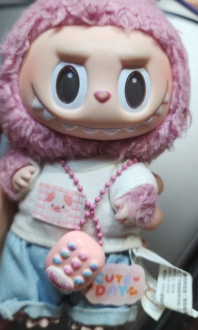 Pink labubu with customize clothes (Category: Plushies & Soft Toys) located in Baguio. Submitted by coffeesilvershadow_28 (Listing ID 1465168032, Image 1). Description: - From HK box. - With customize clothes and accessory -With SOU and signs of wear and minimal paint chip sa ilong nya. Buy as is - With etiketa and searchable ung po ung qr code - Size: APprox. 7 inch - Baguio dropping - Jnt shipping- Paymnet first plus sf.