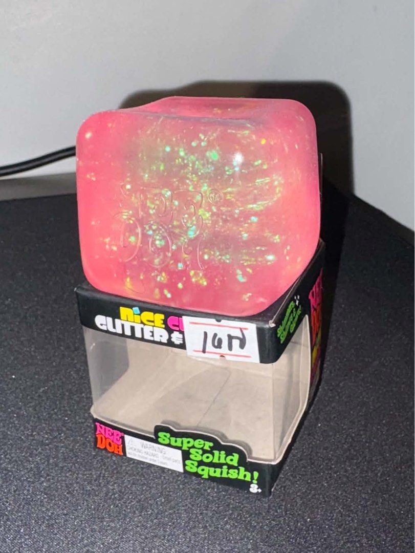 Pink NeeDoh Nice Cube Glitter and Glow (Category: Interactive Toys) located in Quezon City. Submitted by exndrd (Listing ID 1465003576, Image 2). Description: - Item: NeeDoh Nice Cube Fidget Toy - Color: Pink (Glitter & Glow version) - Texture: Super solid squish - Condition: Open packaging with original box included (as pictured) - Use: Great sensory toy and stress ball alternative.