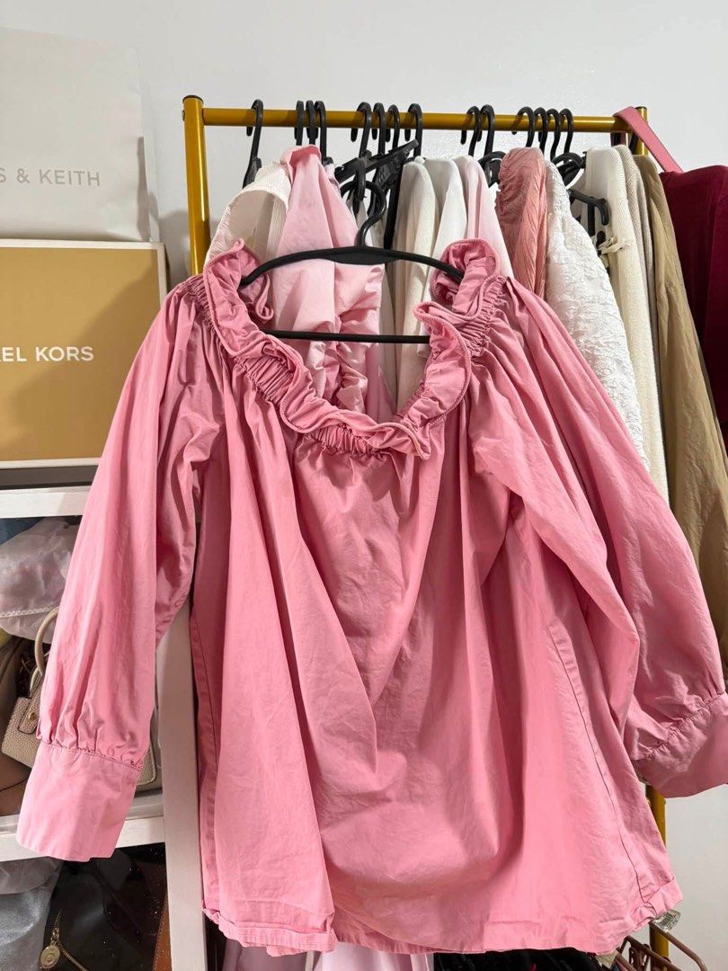 Pink off-shoulder ruffled long sleeve blouse (Category: Longsleeves) located in Trece Martires City. Submitted by king2318 (Listing ID 1465004499, Image 1). Description: - Color: Pretty pink - Design: Versatile ruffled neckline (can be worn off-shoulder or pulled up) - Sleeves: Long sleeves with buttoned cuffs - Material: Light, super flowy cotton - Styling: Easy to match with jeans or skirts for a casual look.