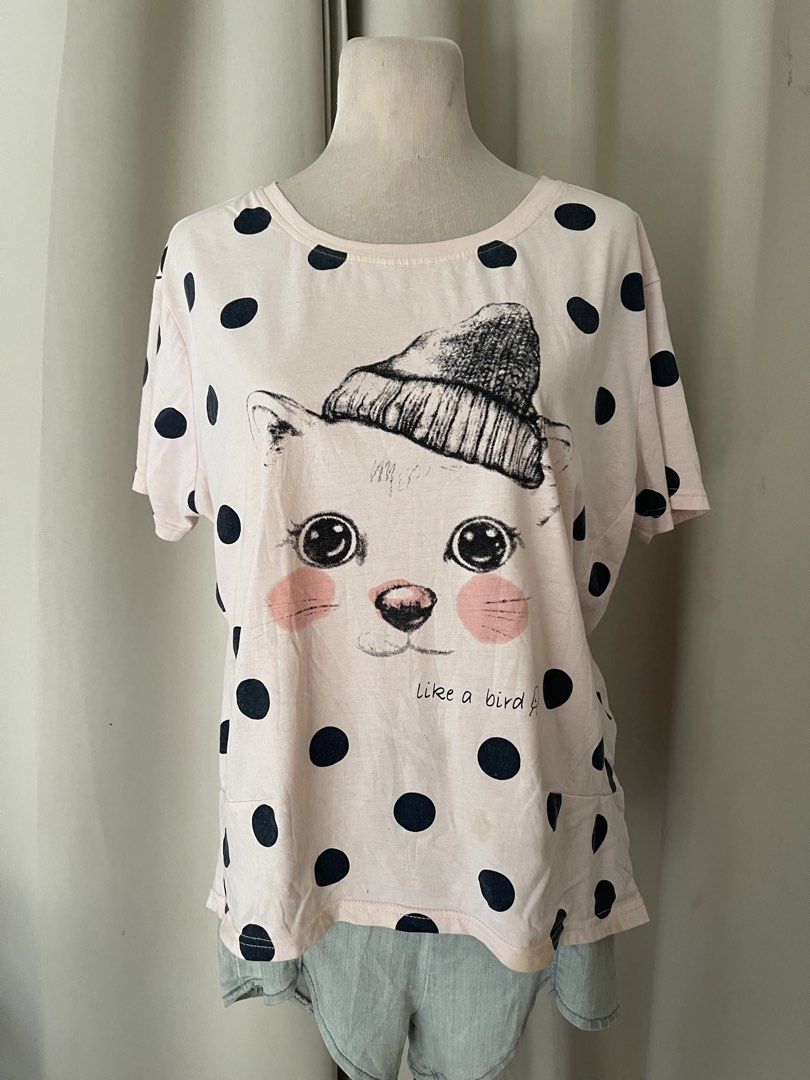 Pink polka dot cat ktee (Category: Shirts) located in Cainta. Submitted by zlove111 (Listing ID 1464969784, Image 1). Description: - Color/Pattern: Pastel pink with all-over black polka dots - Design: Cute cat face wearing a beanie with 'like a bird' text - Fit: Relaxed fit with short sleeves and round neckline - Material: Super soft and comfortable cotton - Condition: Brand new / Excellent pre-loved (adjust as needed) - Perfect for: Casual every