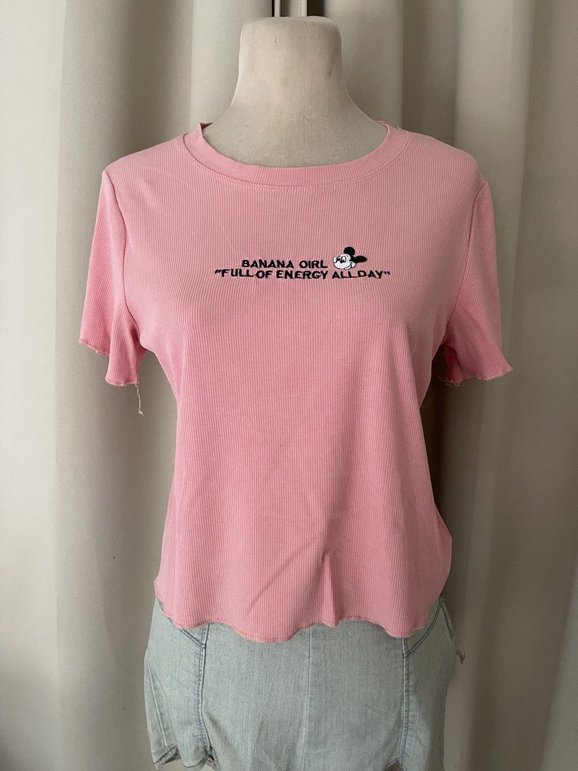 Pink ribbed cotton semi crop embroid (Category: Shirts) located in Cainta. Submitted by zlove111 (Listing ID 1464969834, Image 1). Description: - Color: Pink - Material: Soft and comfortable knit fabric - Design: Ribbed texture with cute lettuce hem details on sleeves and bottom - Graphic: Mickey Mouse face with 'BANANA GIRL "FULL OF ENERGY ALLDAY"' chest embroidery - Neckline: Classic round ribbed neckline - Fit: Casual everyday top, easy to sty