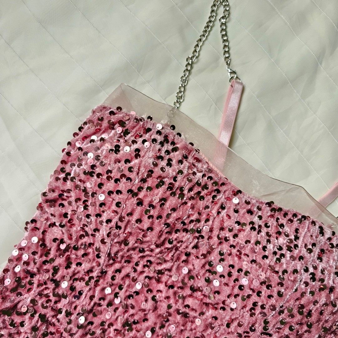Pink sequin tube top with chain straps (Category: Sleeveless) located in Baguio. Submitted by mybirken.stuffph (Listing ID 1465076553, Image 3). Description: - Style: Pink sequin tube top with crushed velvet texture - Details: Sheer mesh trim on top edge, stretchy smocked back panel - Straps: Pink fabric straps attached to chunky silver chains - Best for: Parties, clubs, and night outs - Condition: Brand new / Excellent.