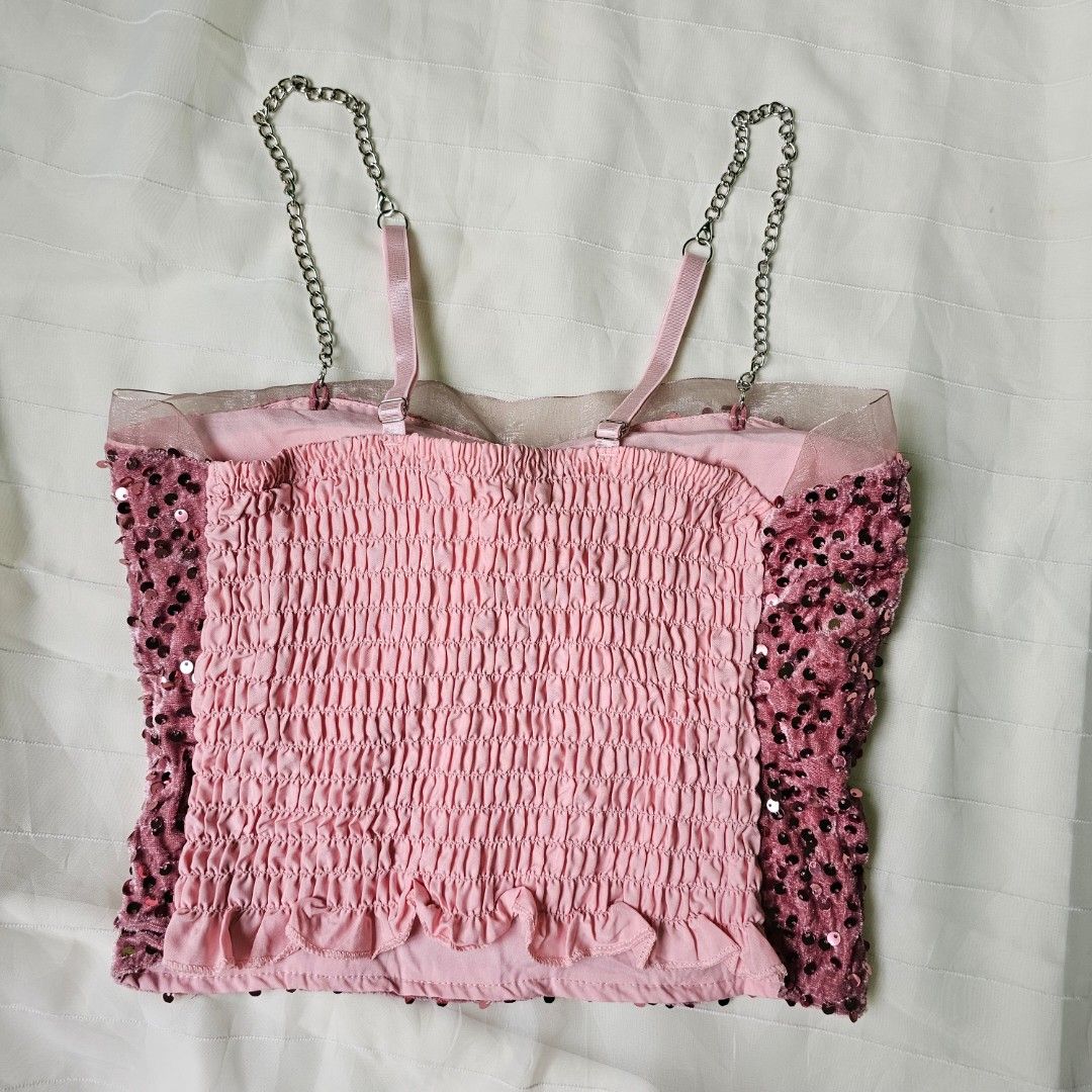 Pink sequin tube top with chain straps (Category: Sleeveless) located in Baguio. Submitted by mybirken.stuffph (Listing ID 1465076553, Image 2). Description: - Style: Pink sequin tube top with crushed velvet texture - Details: Sheer mesh trim on top edge, stretchy smocked back panel - Straps: Pink fabric straps attached to chunky silver chains - Best for: Parties, clubs, and night outs - Condition: Brand new / Excellent.