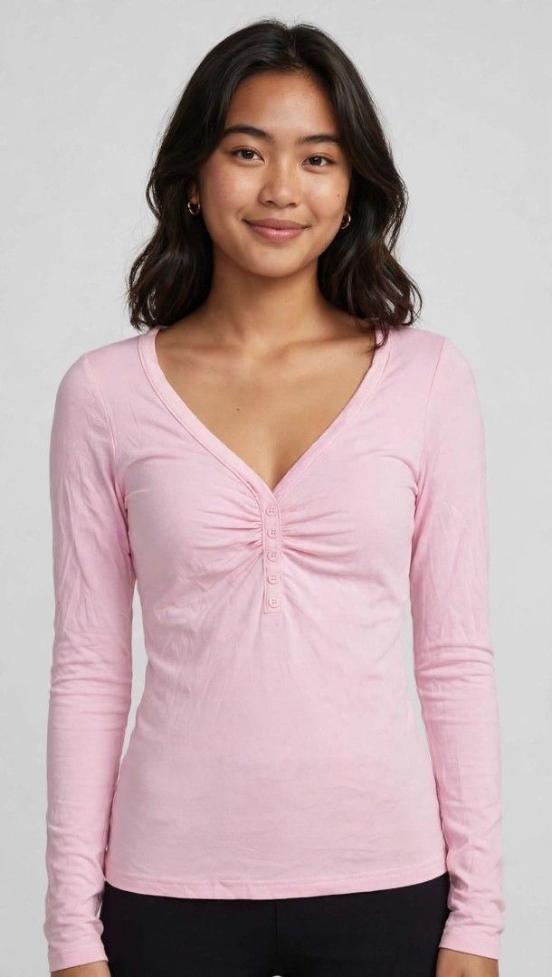 Pink V-Neck Long Sleeve Ruched Button Top (Category: Longsleeves) located in Pasay City. Submitted by lylaineapparel30 (Listing ID 1465090374, Image 1). Description: - Color: Soft pink - Design: V-neckline with small front button closure and ruched chest detailing - Fit: Fitted silhouette that flatters the figure - Material: Simple, lightweight, and comfortable - Styling: Perfect for casual daily outfits or as a layering piece under jackets.