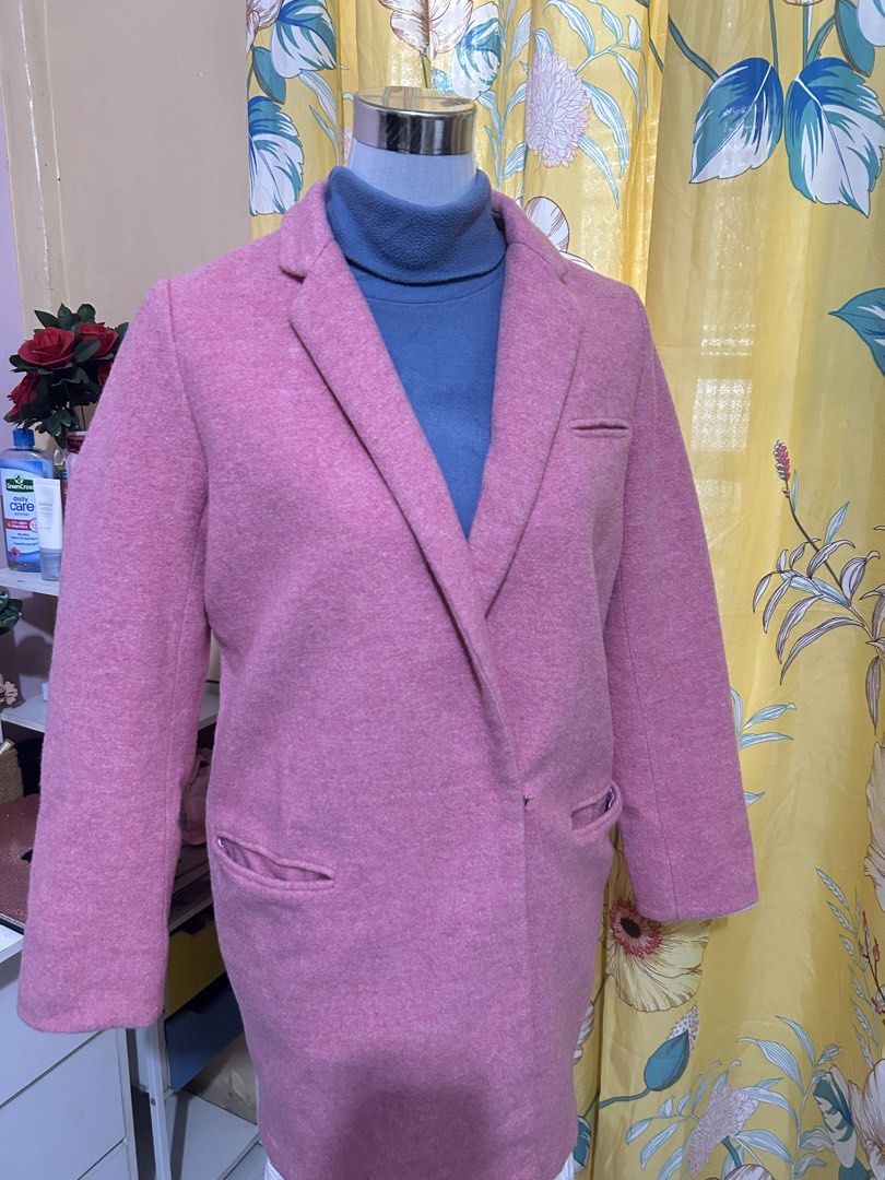 Pink wool winter coat (Category: Coats, Jackets and Outerwear) located in Makati City. Submitted by aizy_sell (Listing ID 1465024763, Image 3). Description: - Color: Solid pink - Material: Heavy wool fabric for colder weather - Length: Mid-length (covers past the hips) - Design: Structured lapels, long sleeves, and clean stitching - Pockets: Two front pockets plus a small chest pocket detail - Styling: Perfect for layering over sweaters and dress