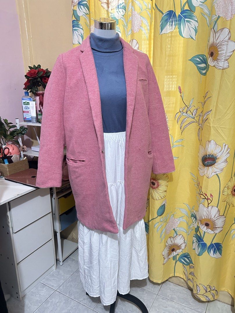 Pink wool winter coat (Category: Coats, Jackets and Outerwear) located in Makati City. Submitted by aizy_sell (Listing ID 1465024763, Image 2). Description: - Color: Solid pink - Material: Heavy wool fabric for colder weather - Length: Mid-length (covers past the hips) - Design: Structured lapels, long sleeves, and clean stitching - Pockets: Two front pockets plus a small chest pocket detail - Styling: Perfect for layering over sweaters and dress