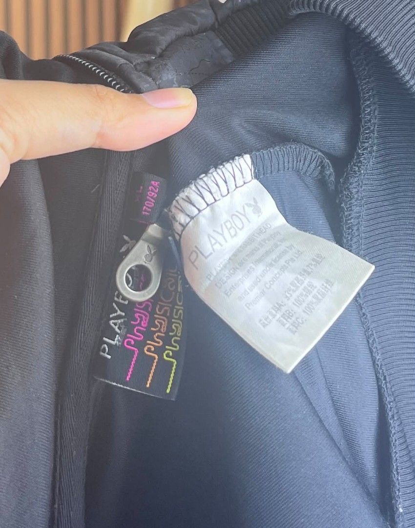 Playboy Black Bomber Jacket with Patch (Category: Coats, Jackets and Outerwear) located in Dumaguete. Submitted by morie_luna15 (Listing ID 1464978965, Image 2). Description: - Authentic black Playboy bomber jacket - Best fit for Small-Medium Only - Front zipper closure with a stand-up collar - Subtle all-over print body with solid black sleeves and ribbed cuffs - Embroidered Playboy rabbit head logo on the chest - Stylish '53 crest patch on the 