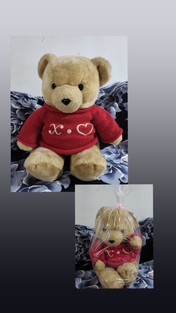 Plush Teddy Bear in Red Sweater with Heart (Category: Plushies & Soft Toys) located in Manila. Submitted by gelvy1316 (Listing ID 1465056121, Image 1). Description: - Product: Fluffy teddy bear with soft light brown fur and dark button eyes - Outfit: Cozy red knitted sweater with embroidered white "X.O." and heart lettering - Condition: Brand new, still in original plastic packaging adorned with a pink ribbon - Ideal Use: Perfect as a thoughtful 