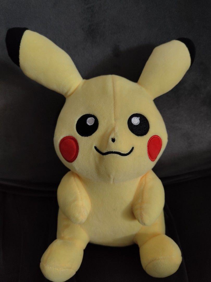 Pokémon Pikachu Stuffed Animal Plush Toy (Category: Plushies & Soft Toys) located in Manila. Submitted by youngcrystal_063c61 (Listing ID 1465018037, Image 1). Description: - Vibrant yellow Pikachu plush toy - Features iconic black-tipped ears, red cheeks, and embroidered facial details - Soft and huggable fabric material - Designed in a cute sitting upright posture.