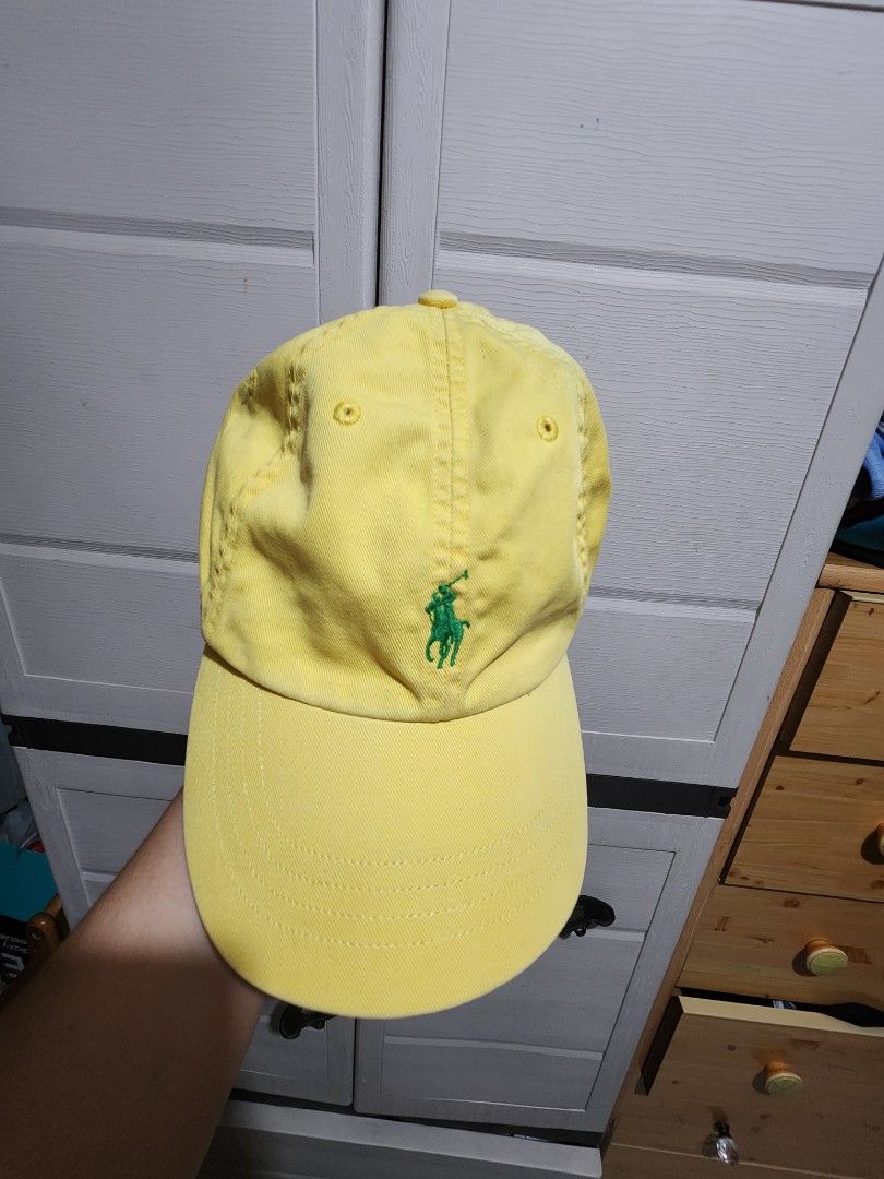 Polo by Ralph Lauren yellow cap (Category: Caps & Hats) located in Quezon City. Submitted by amber___18 (Listing ID 1465045823, Image 1). Description: - Brand: Ralph Lauren - Color: Bright yellow with green embroidered pony - Details: "POLO" stitched above the back opening and navy/white interior brand label - Fit: One size fits most with an adjustable brown leather strap and metal buckle.