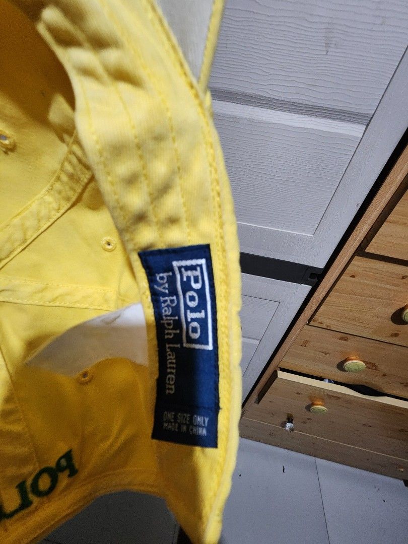 Polo by Ralph Lauren yellow cap (Category: Caps & Hats) located in Quezon City. Submitted by amber___18 (Listing ID 1465045823, Image 2). Description: - Brand: Ralph Lauren - Color: Bright yellow with green embroidered pony - Details: "POLO" stitched above the back opening and navy/white interior brand label - Fit: One size fits most with an adjustable brown leather strap and metal buckle.
