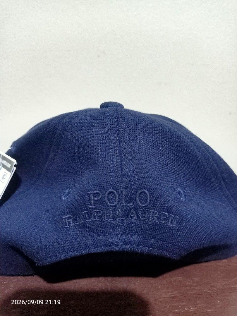 Polo Ralph Lauren Cap (Category: Caps & Hats) located in Las Pinas. Submitted by OmengSoyT (Listing ID 1464970581, Image 3). Description: - Brand: Polo Ralph Lauren - Color: Navy Blue - Condition: Brand new with original tags attached - Material: Combination of cotton and polyester materials - Design: Big embossed logo on front with smaller embroidered lettering on the back - Fit: (Osfa) Adjustable strap closure for a custom fit.