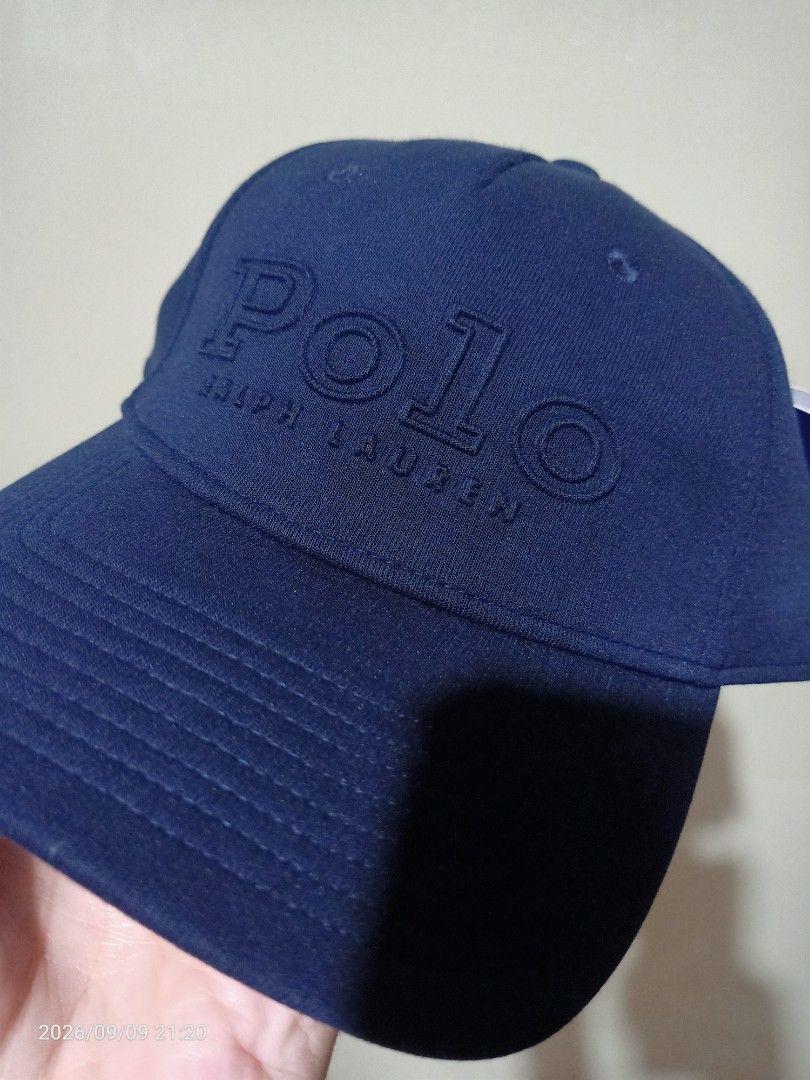 Polo Ralph Lauren Cap (Category: Caps & Hats) located in Las Pinas. Submitted by OmengSoyT (Listing ID 1464970581, Image 1). Description: - Brand: Polo Ralph Lauren - Color: Navy Blue - Condition: Brand new with original tags attached - Material: Combination of cotton and polyester materials - Design: Big embossed logo on front with smaller embroidered lettering on the back - Fit: (Osfa) Adjustable strap closure for a custom fit.