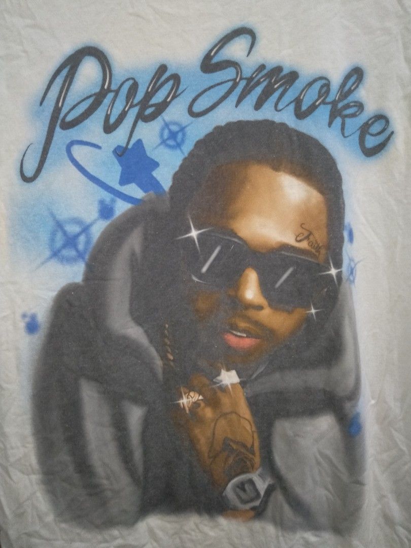 Pop Smoke Airbrush Rap Tee White (Category: Tshirts & Polo Shirts ) located in Manila. Submitted by jaradhiggins24 (Listing ID 1465114929, Image 2). Description: - White graphic t-shirt featuring Pop Smoke airbrush art and signature script text - Size: Medium - Material: 100% cotton with a standard crew neck and tagless printed neck label - Condition: Good overall, but please note a couple of small holes near the hem.