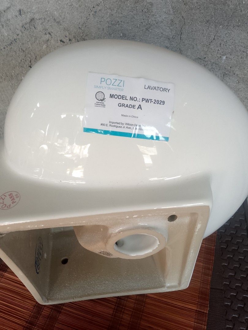 Pozzi PWT-2029 Corner Lavatory Sink (Category: Bathroom & Kitchen Fixtures) located in Taguig. Submitted by generygwap31973 (Listing ID 1465012463, Image 3). Description: - Brand: Pozzi (Model: PWT-2029) - Type: Grade A white ceramic corner lavatory sink - Condition: Unused porcelain with original factory sticker - Inclusions: Wrapped metal drain hardware pipe underneath - Finish: Clean and ready for bathroom installation.