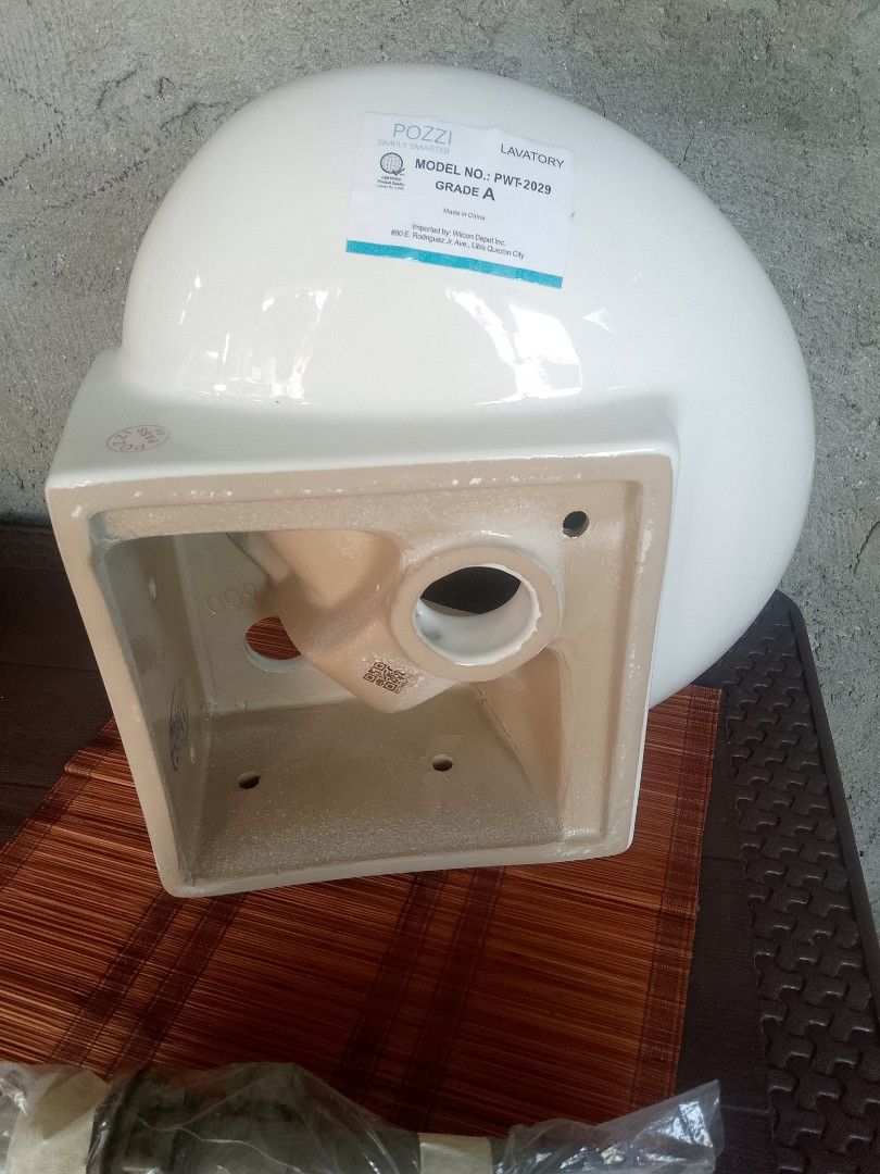 Pozzi PWT-2029 Corner Lavatory Sink (Category: Bathroom & Kitchen Fixtures) located in Taguig. Submitted by generygwap31973 (Listing ID 1465012463, Image 2). Description: - Brand: Pozzi (Model: PWT-2029) - Type: Grade A white ceramic corner lavatory sink - Condition: Unused porcelain with original factory sticker - Inclusions: Wrapped metal drain hardware pipe underneath - Finish: Clean and ready for bathroom installation.