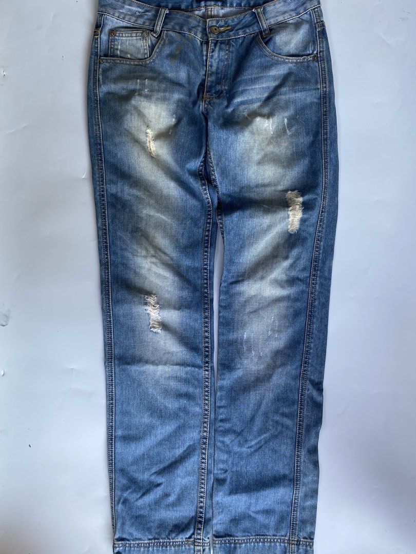 Prada Distressed Denim Jeans (Category: Jeans) located in Manila. Submitted by deguertoje73072 (Listing ID 1465008919, Image 2). Description: - Brand: Prada - Wash: Light wash with factory distressing and whiskering - Fit: Straight leg - Details: Iconic triangular Prada logo patch on the back waistband, branded buttons and rivets - Pockets: Classic five-pocket design - Hem: Double-stitched hems - Condition: Great staple piece for casual outfits.
