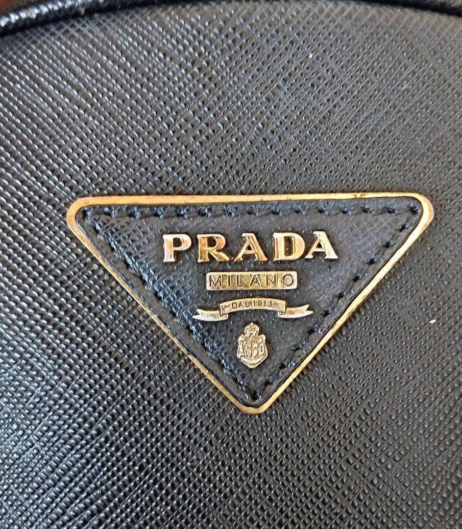 PRADA HANDBAG (Category: Shoulder Bags) located in Legazpi City. Submitted by nashaiza (Listing ID 1465000907, Image 2). Description: Prada Handbag Color: Black Made in Italy Code: 8 Lampo under zipper Gold Hardware *authenticity not guarantee MOP: GCash Courier: J&T Express.
